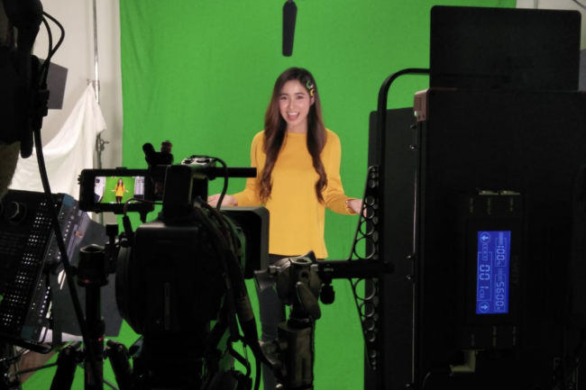 Presenter filming in a professional green screen studio
